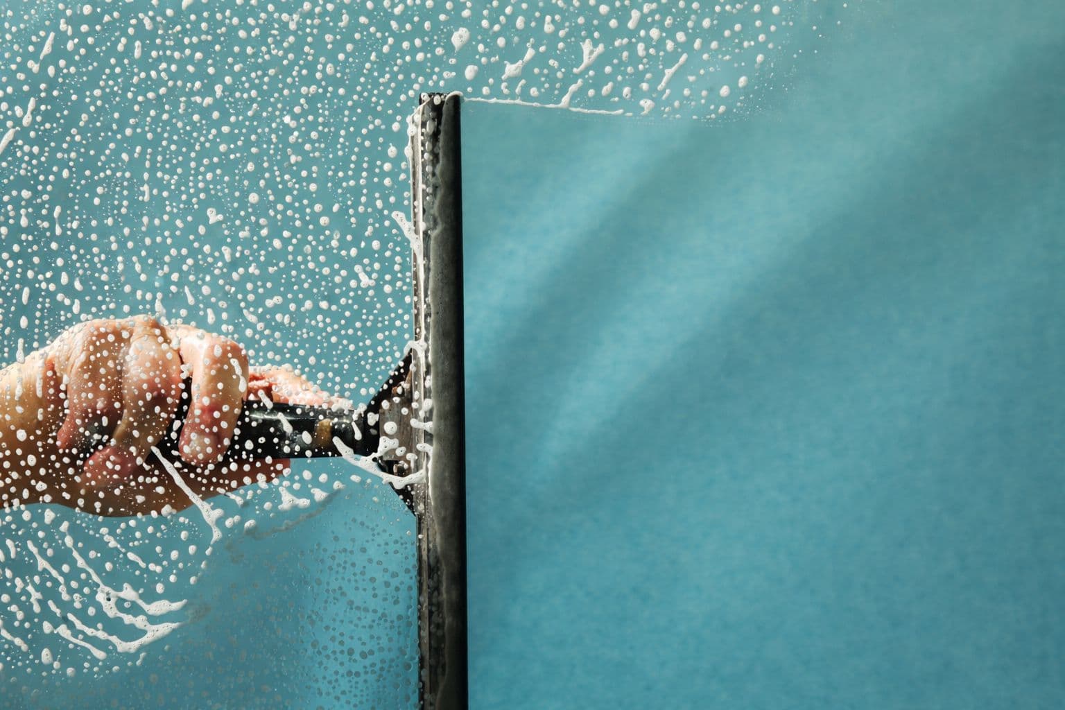 MrBen window cleaning professional working on a modern home
